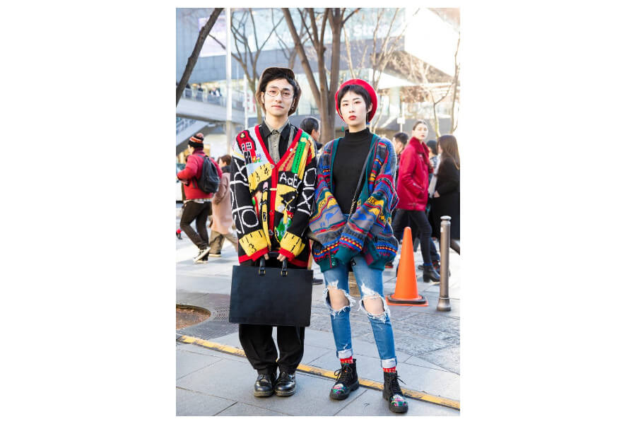 Two individuals in colorful eclectic outfits embodying 70s fashion and style trends.