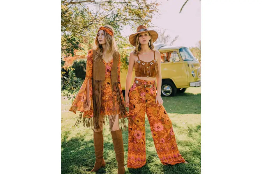 Two women showcase vibrant 1970s fashion trends in bohemian outfits and sun hats.