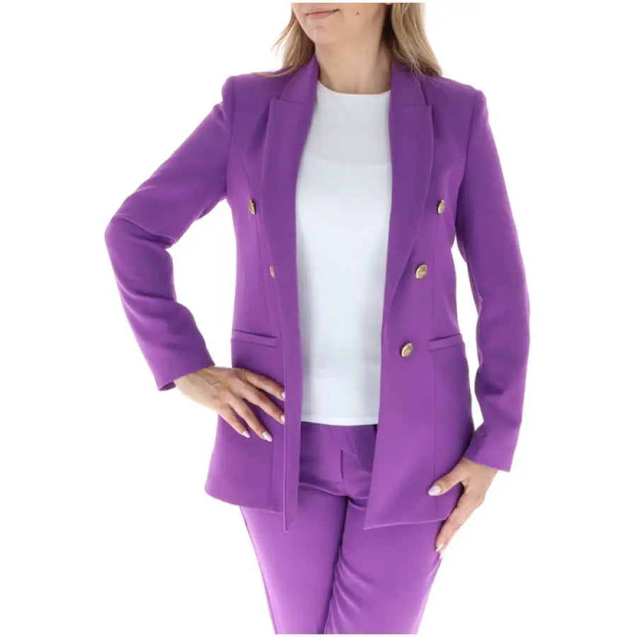 Vibrant purple women’s blazer with gold buttons over a white top by Sol Wears Women