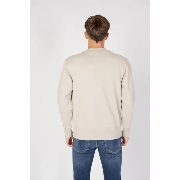 Back view of person wearing cream sweater, blue jeans - Calvin Klein Jeans Men Sweatshirts