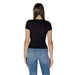 Back view of a person in fitted black t-shirt and blue jeans by Tommy Hilfiger