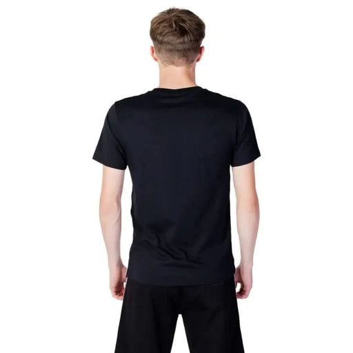 Back view of a person wearing Moschino Underwear Men T-Shirt in plain black