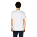 Back view of a person in a plain white Moschino Underwear t-shirt and dark jeans