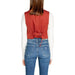 Back view of a person in a red sleeveless top and blue jeans wearing Vero Moda Gilet