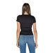 Back view of a model in a black t-shirt and blue Tommy Hilfiger jeans