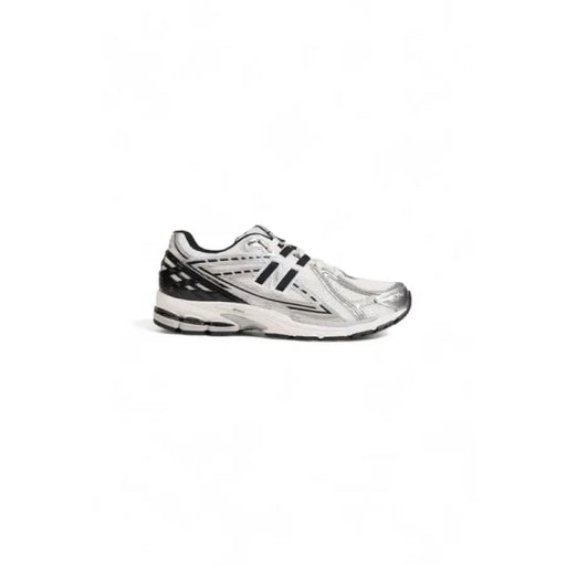 White and black New Balance athletic running shoe with mesh upper and cushioned sole