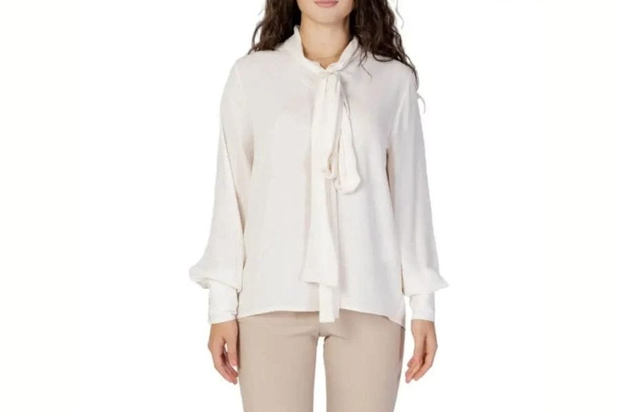 White tie-neck blouse with long sleeves for a stylish first date outfit.