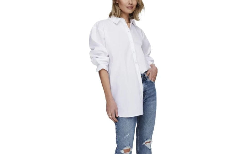 White button-down shirt with distressed blue jeans, ideal holiday outfit inspiration.