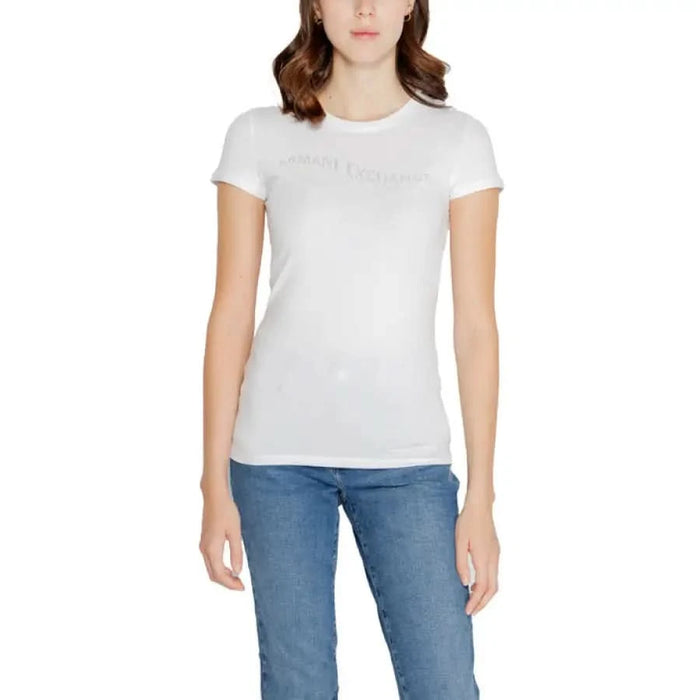 White crew neck T-shirt worn by a woman paired with blue jeans from Armani Exchange