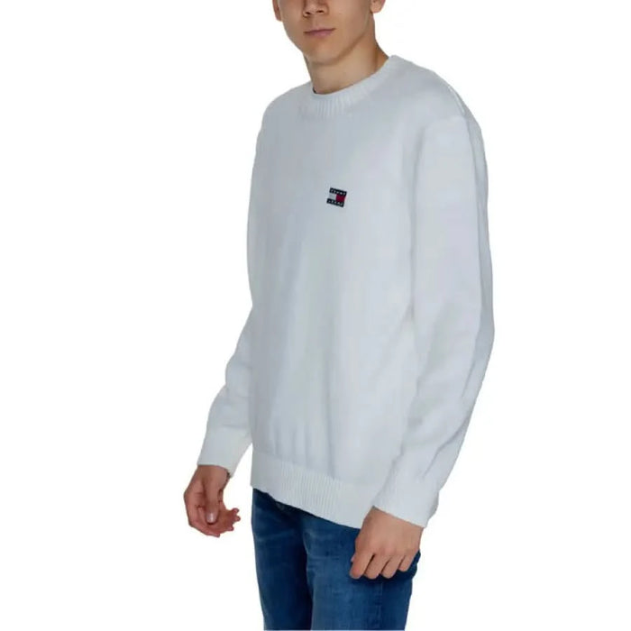 White crewneck sweater featuring a small Tommy Hilfiger logo on the chest