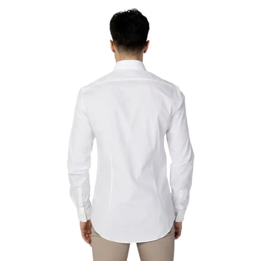 Calvin Klein Men’s white dress shirt worn by a person, viewed from behind