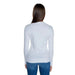 Back view of a long-haired woman wearing Guess Women’s Knitwear white long-sleeved sweater