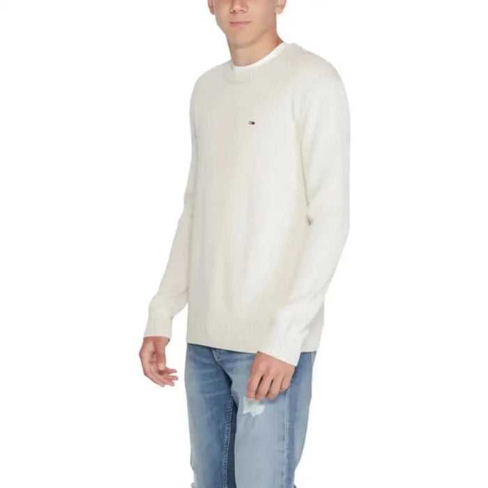 White long-sleeved Tommy Hilfiger sweater featuring a small logo on the chest