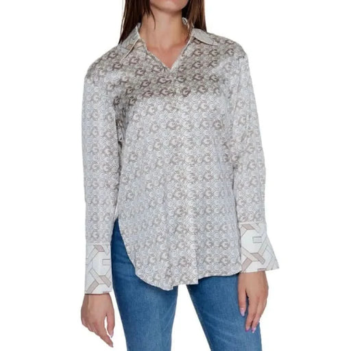 White patterned Guess Women Shirt with long sleeves paired with blue jeans