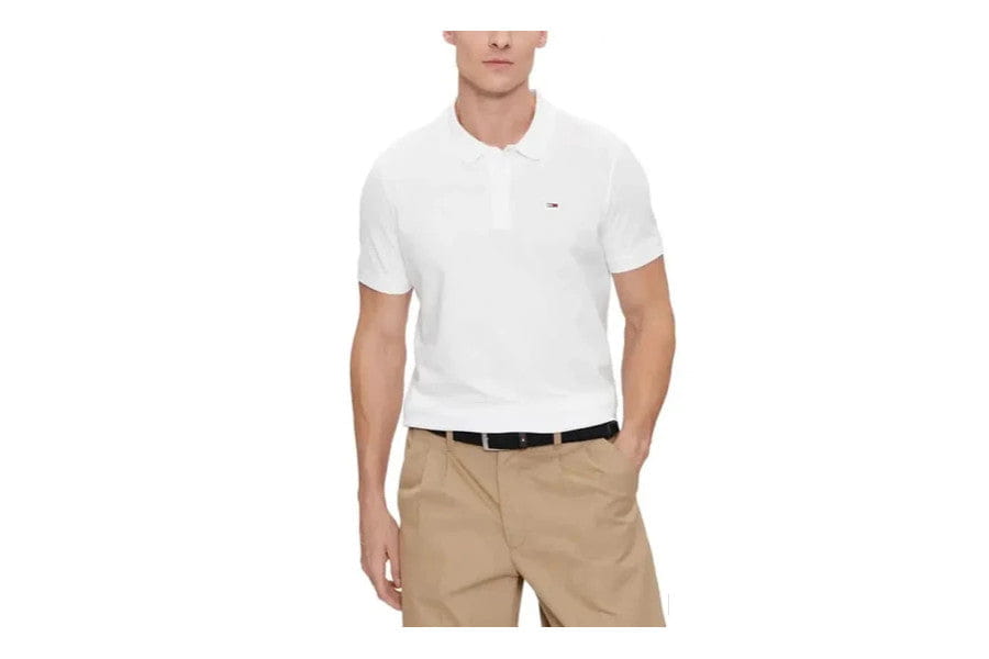 White polo shirt paired with khaki shorts and a black belt in minimalist apparel.