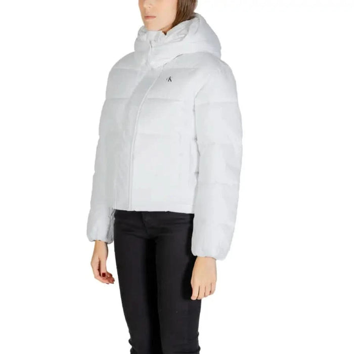 White puffy hooded winter jacket paired with black pants from Calvin Klein Jeans