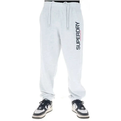 White Superdry sweatpants featuring vertical brand print on left leg