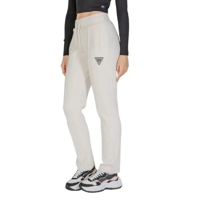 White sweatpants featuring a triangular logo on the thigh from Guess Active Women Trousers