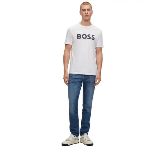 White BOSS t-shirt paired with blue jeans and white sneakers for a stylish look