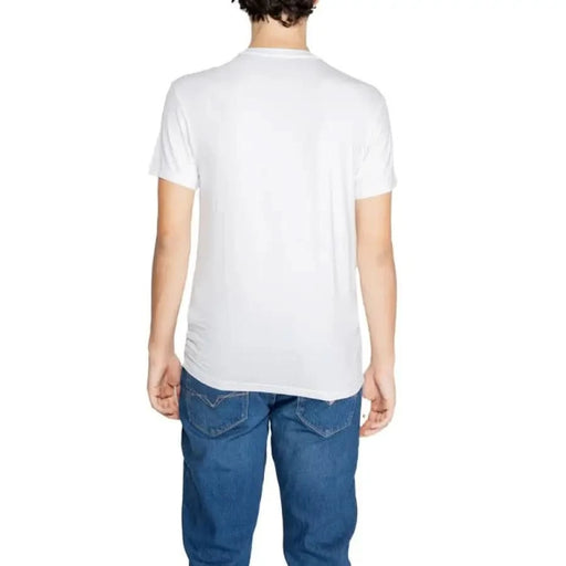 White t-shirt worn by a person from behind, featuring Emporio Armani Underwear branding