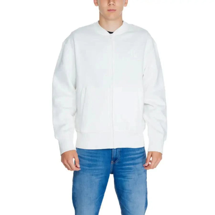 Calvin Klein Jeans Men White Zip-up Bomber Jacket over Blue Jeans - Stylish Menswear Ensemble