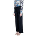 Guess women’s wide-leg black trousers with patterned top and nude heels