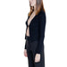 Woman in black cardigan and dark pants from Morgan De Toi knitwear collection