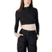 Woman in black crop top and high-waisted cargo pants - Calvin Klein Jeans Women’s T-Shirt