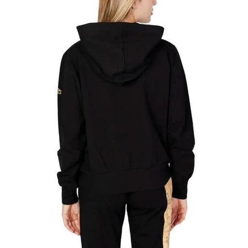 Alviero Martini Prima Classe woman in black hoodie with gold zipper