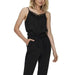 Woman in black jumpsuit with lace detail, urban city style clothing