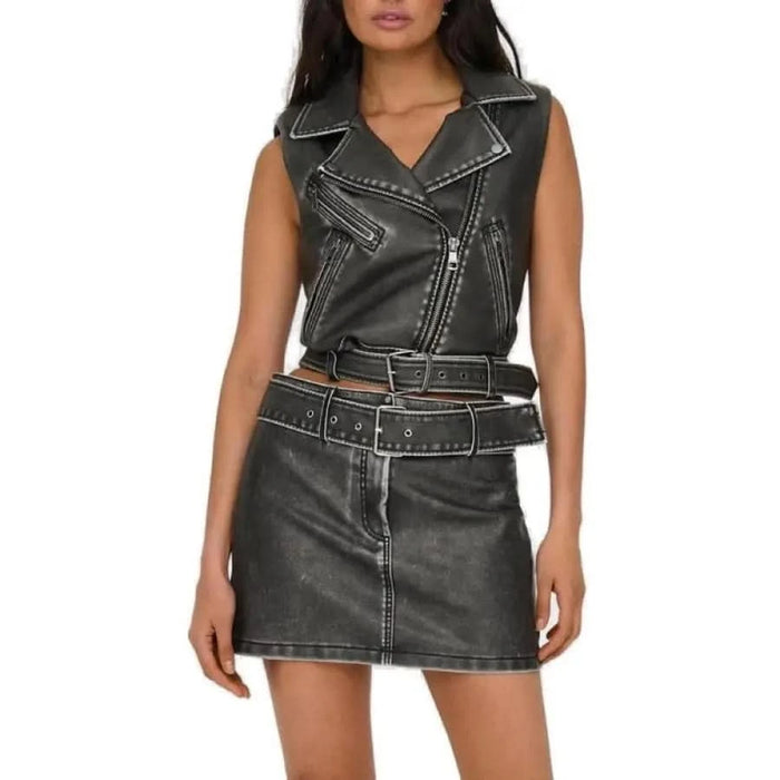 Woman in urban style clothing, black leather women gilet by Only in city setting