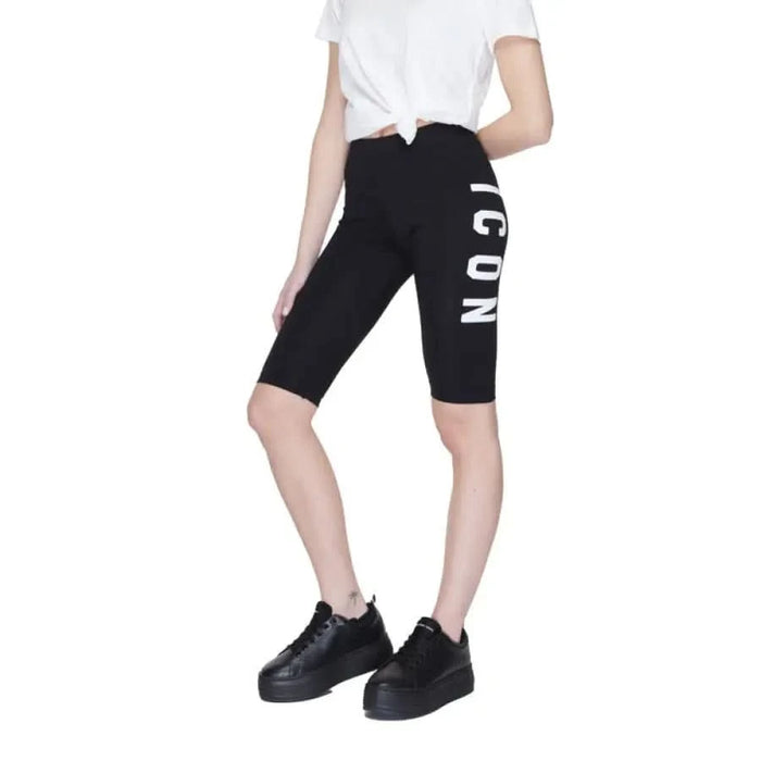 Woman wearing Icon - Icon Men Shorts, black with white lettering on the side