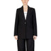 Woman in black suit, white shirt showcasing urban style women blazer for city fashion