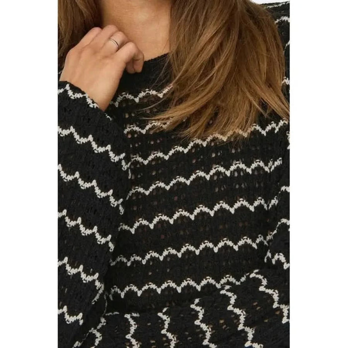 Woman in black and white sweater from Only Women Knitwear, showcasing urban city fashion