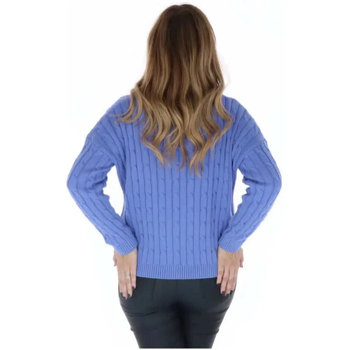 Woman in Superdry women knitwear, blue cable sweater