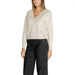 Woman in cream V-neck sweater with black wide-leg pants from Vero Moda Knitwear