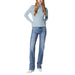 Woman in light blue sweater and blue jeans from Guess Women Knitwear collection