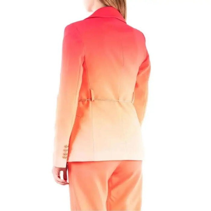 Urban style: Woman in a pink and orange Silence blazer. Shop fashionable women’s clothing