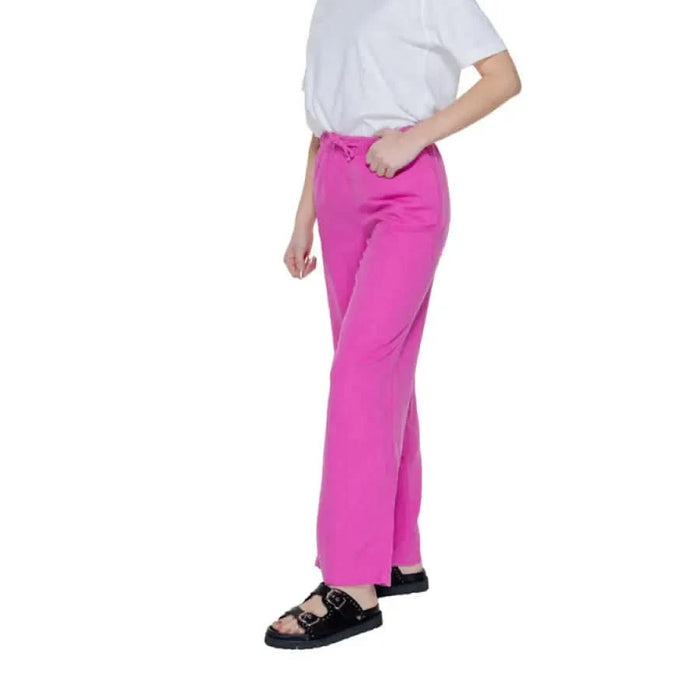 Woman in pink Only trousers and white shirt showcasing urban city style fashion