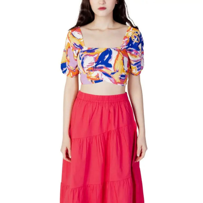 Woman in red skirt and crop top showcasing urban style clothing