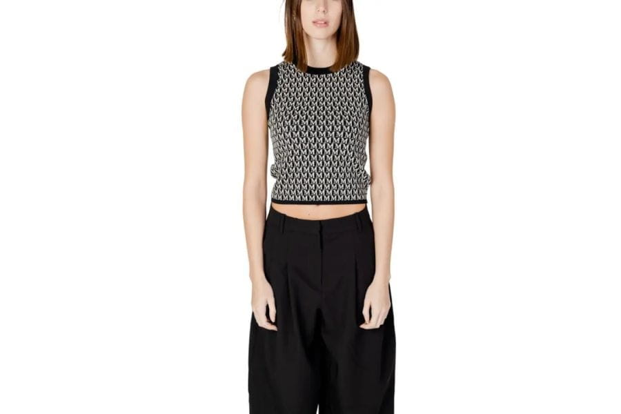 Woman in a patterned crop top and black wide-leg pants for stylish summer outfit ideas.