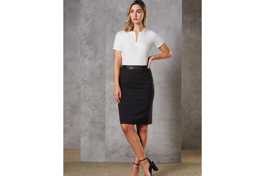 Woman in white blouse and black pencil skirt exuding old money style elegance look.