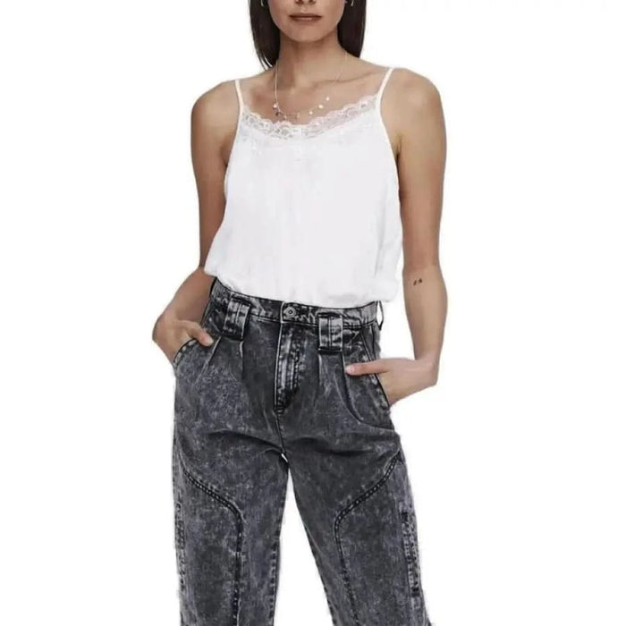 Woman in white top and black jeans showcasing urban city style clothing