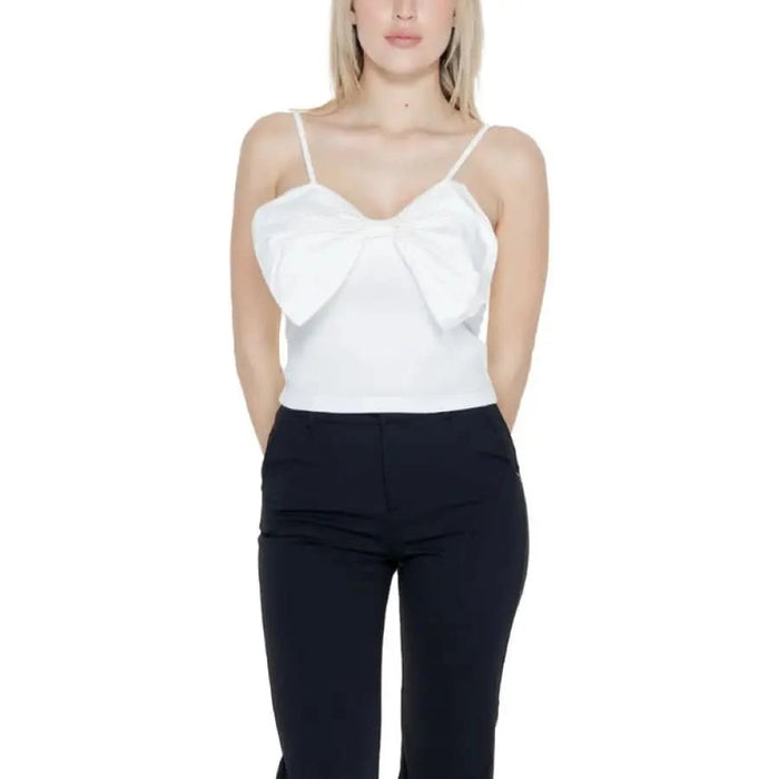 Woman in white top and black pants for Only Women Undershirt, urban city style clothing