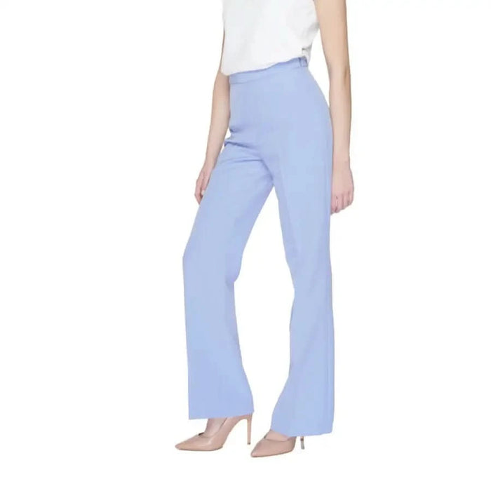 Urban style clothing: Woman in white top and blue pants from Silence Women Trousers collection