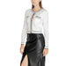 Woman in a white cardigan paired with a black leather skirt from Morgan De Toi