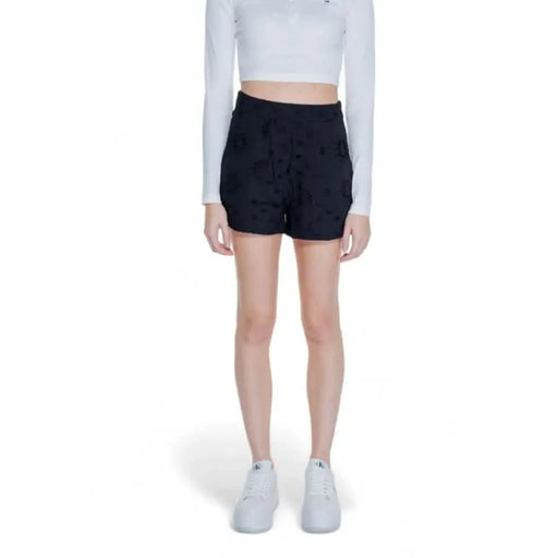 Woman in white crop top, black shorts, and white sneakers - Only Women Short product