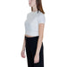 Woman in white cropped t-shirt and black pants from Tommy Hilfiger Jeans Women Knitwear