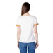 Woman in an Alviero Martini Prima Classe gold trim white T-shirt