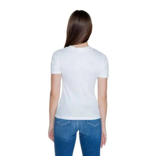 Rear view of woman in Calvin Klein Jeans and white t-shirt